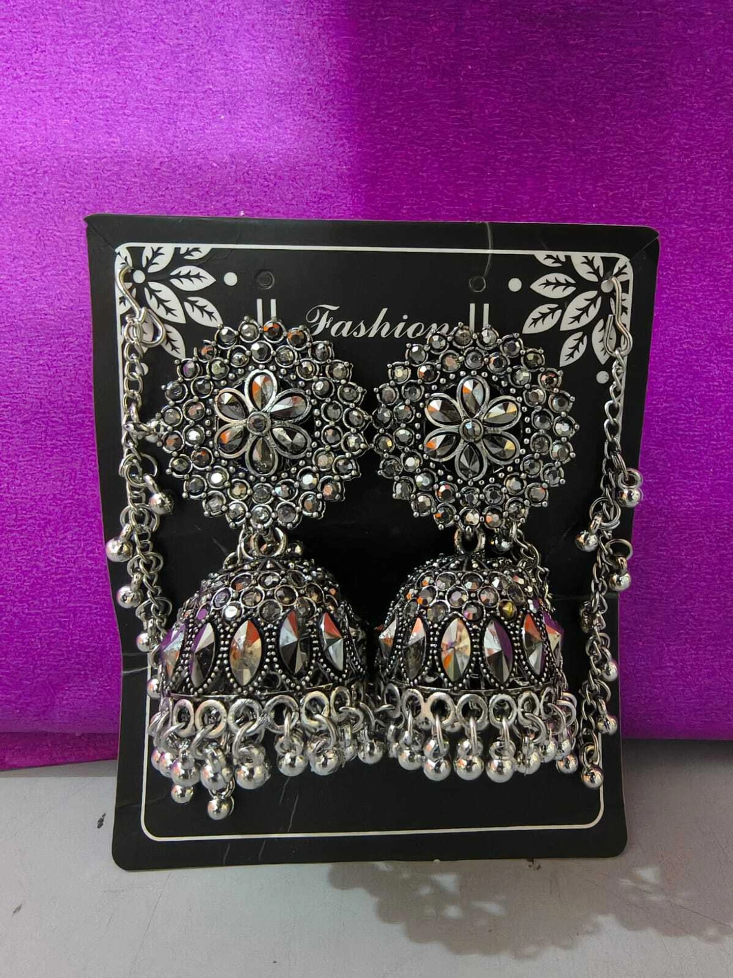 oxidized silver jhumka earrings with chain front view oxidized silver jhumka earrings with chain front view